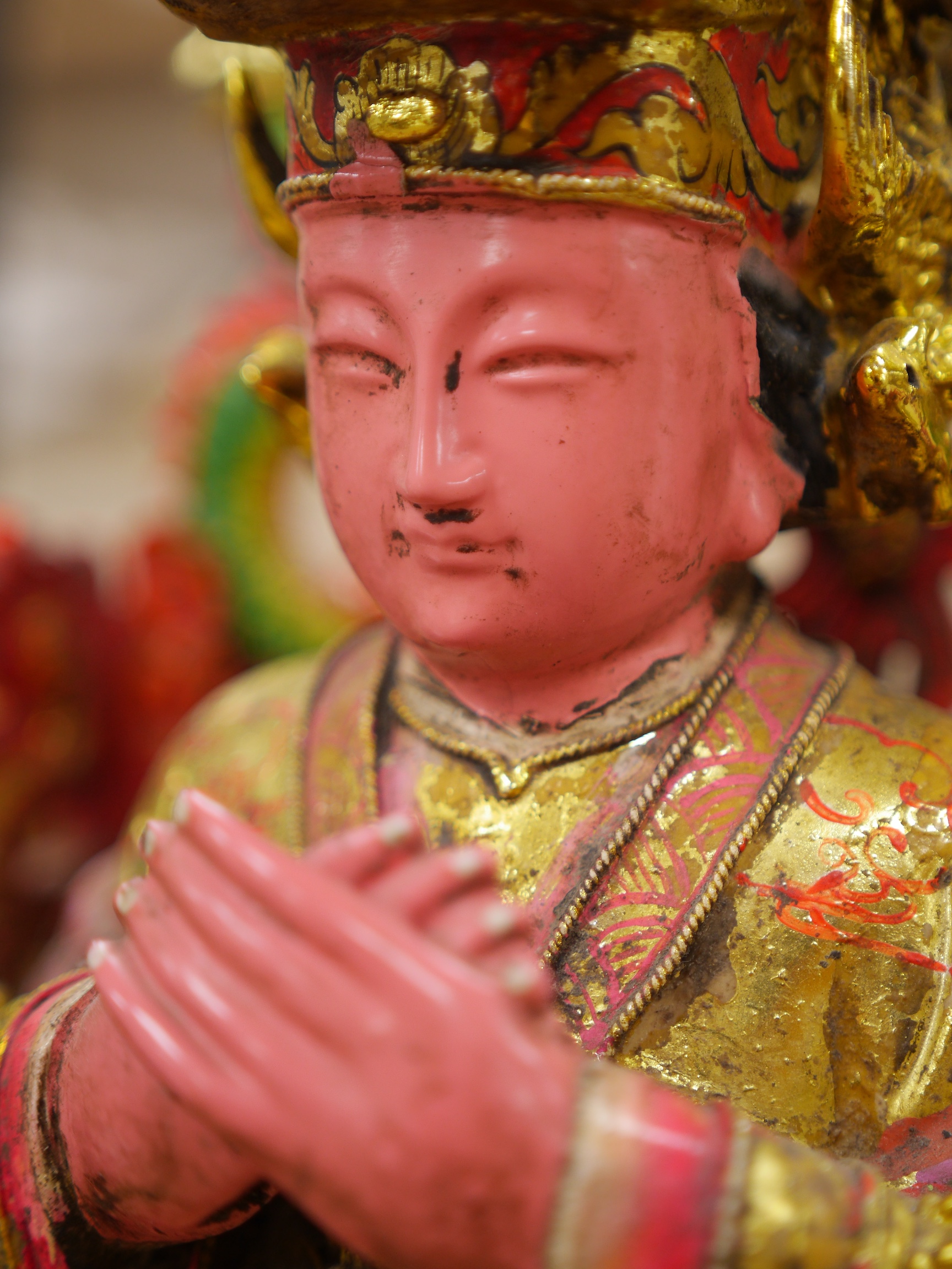 A Chinese gilt and painted composition figure of a seated immortal, 31cm tall. Condition - poor to fair